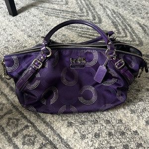 Purple Coach handbag with attachable over the shoulder strap.